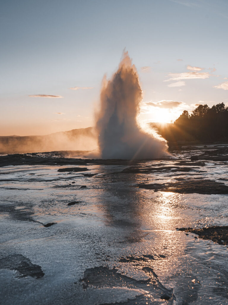 Iceland Great Geysir eruption during sunset
