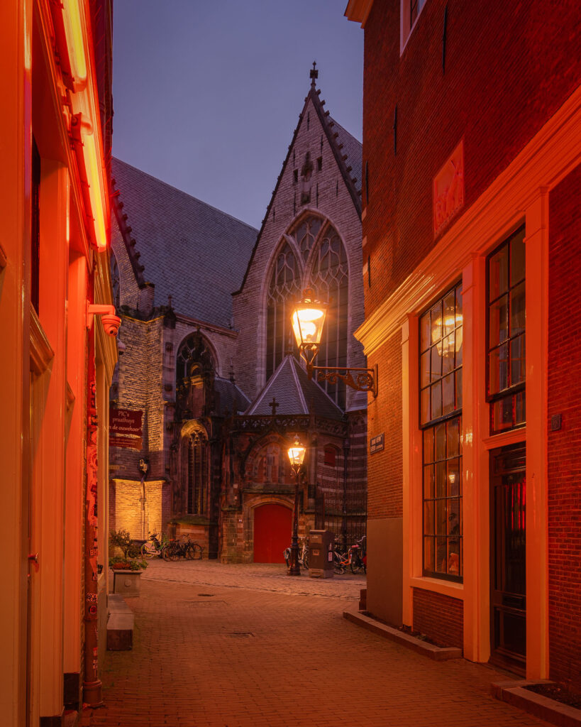 Empty alley in the Amsterdam Red Light district with the Old Church in the background