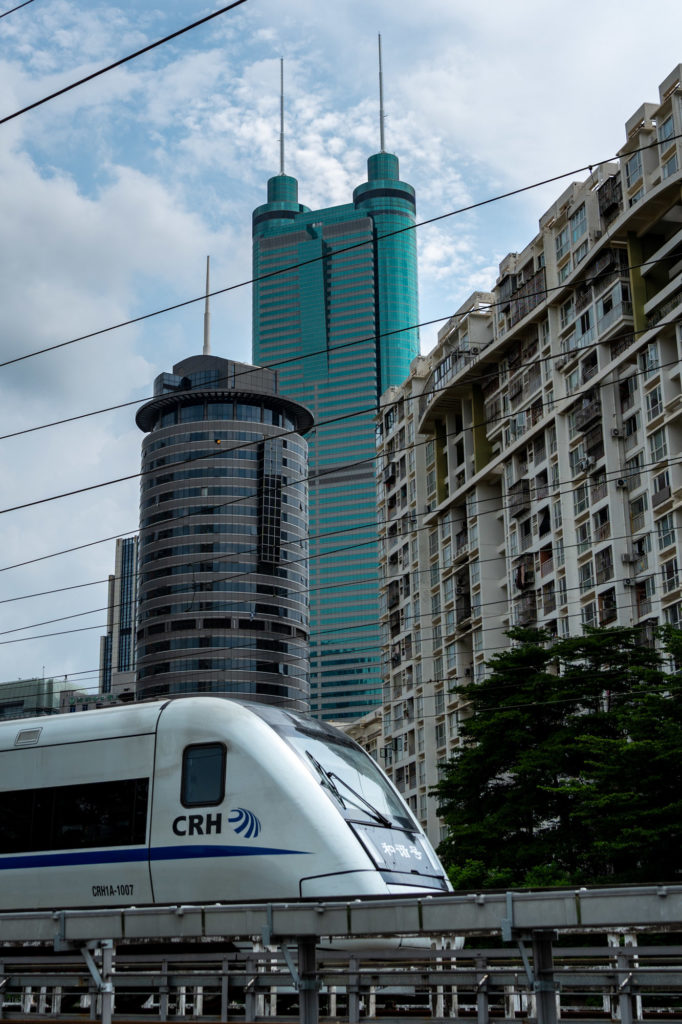 Bullet train passing in front of Shenzhen skyscrapers