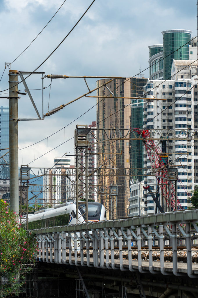 Bullet train passing in front of Shenzhen skyscrapers