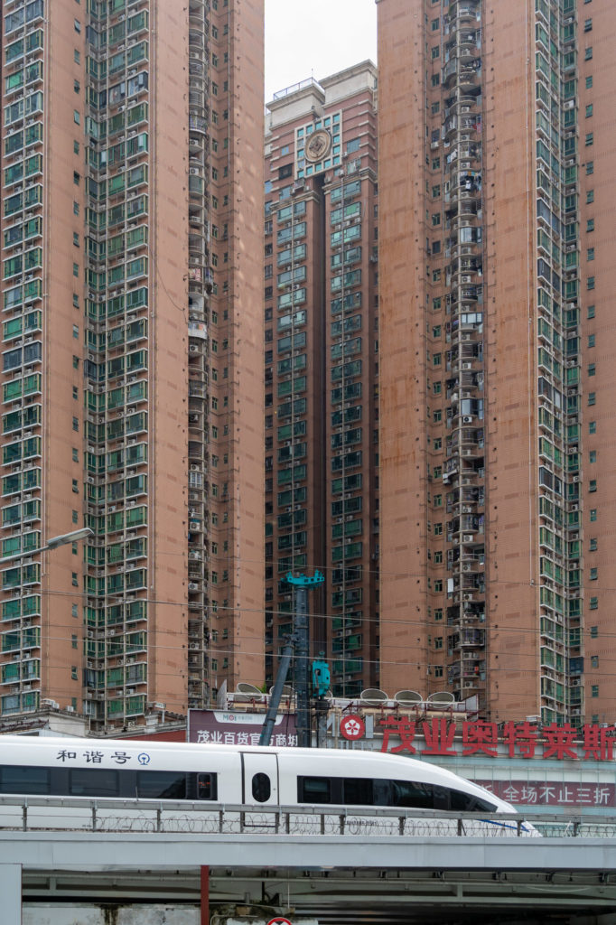 High rise buildings with a CSR Chines High Speed train passing by in front.