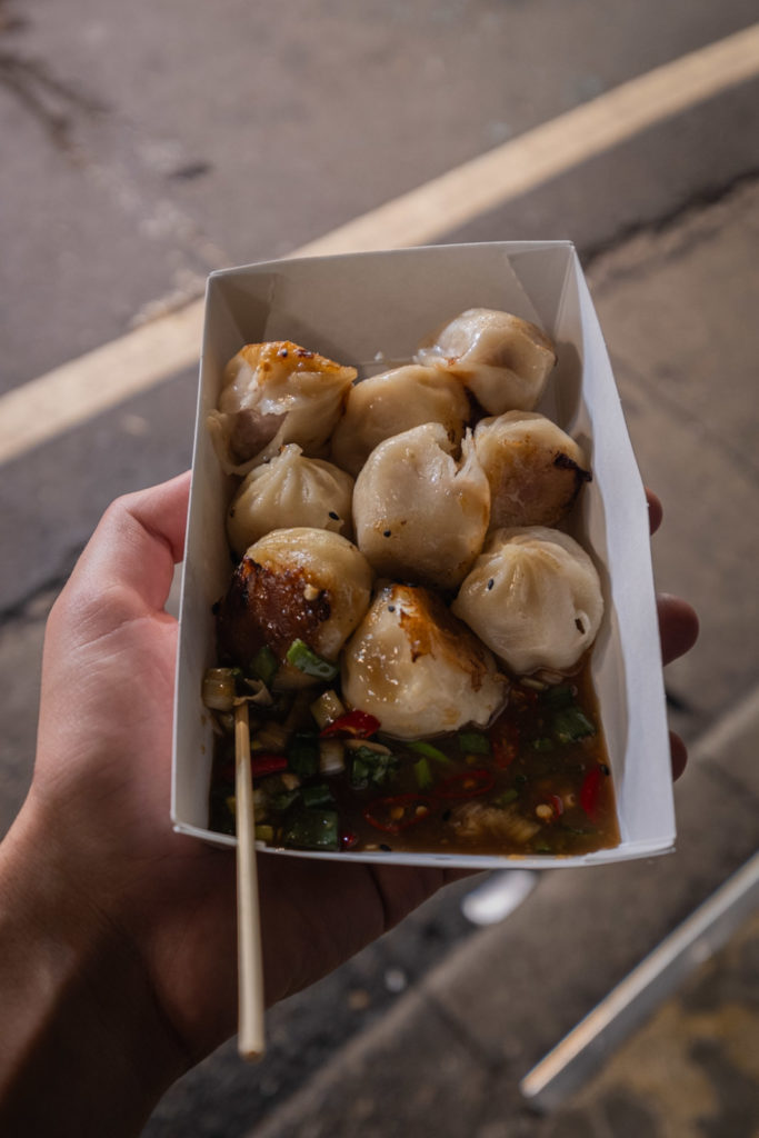 Pan fried dumplings with a dash of chili sauce