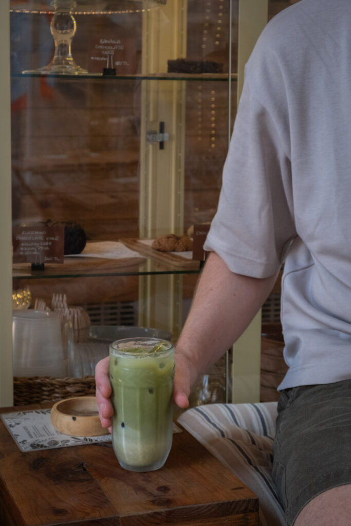 Michiel enjoying a matcha at Petrikor Coffee & Records