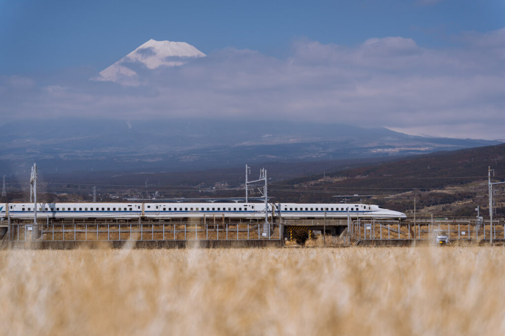 Shinkansen passing by with Mount Fuji in the background