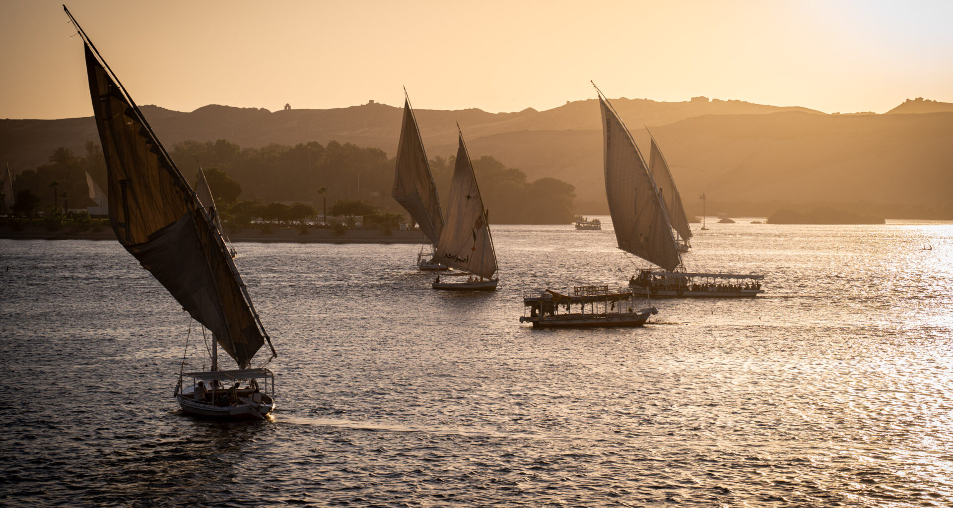 Traditional Feluccas on the nile in Aswan during sunset
