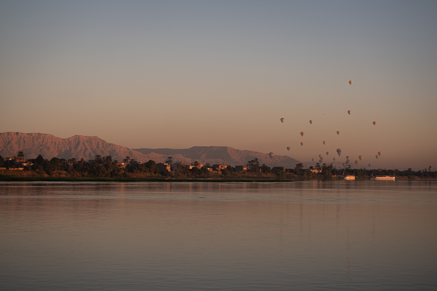 Hot air balloons over the Nile in Luxor during sunrise