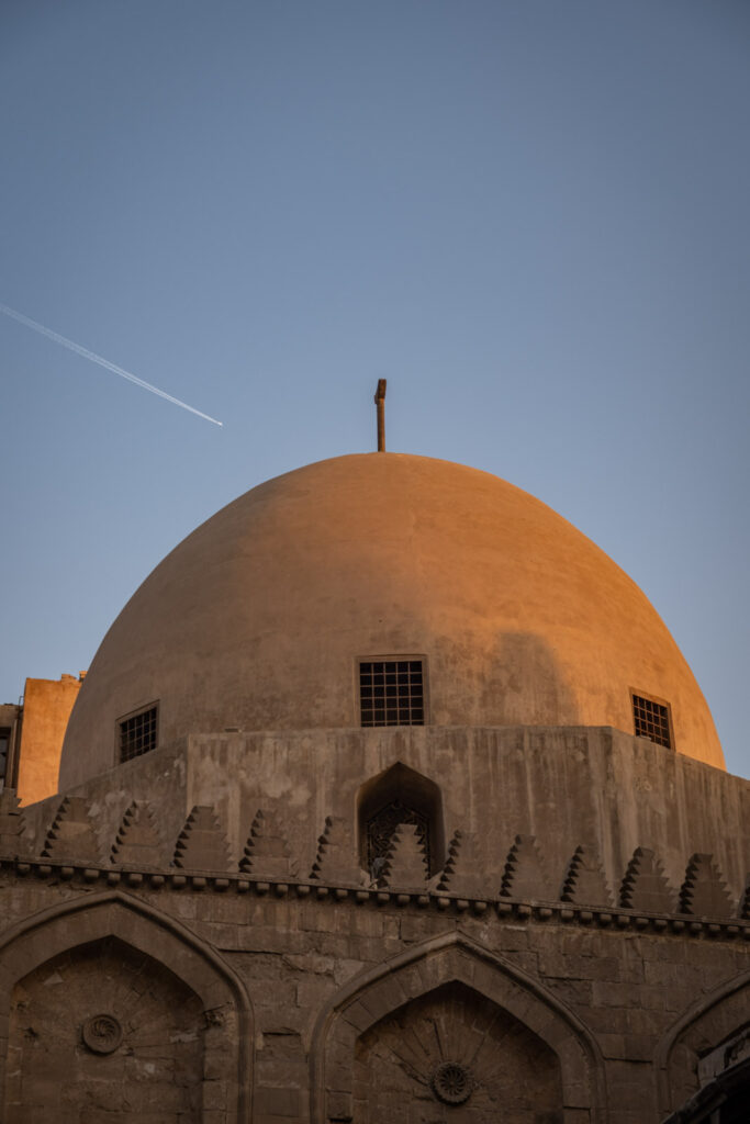 Plane flying above Qalawun Complex