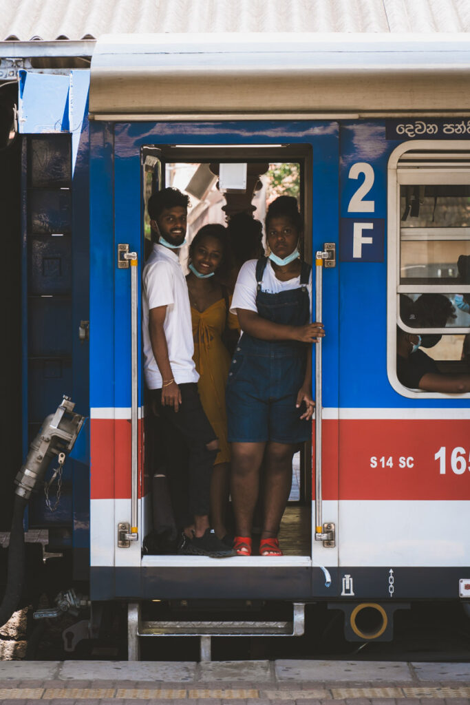 Sri Lankan People in Train Doorframe at at Kandy Train Station