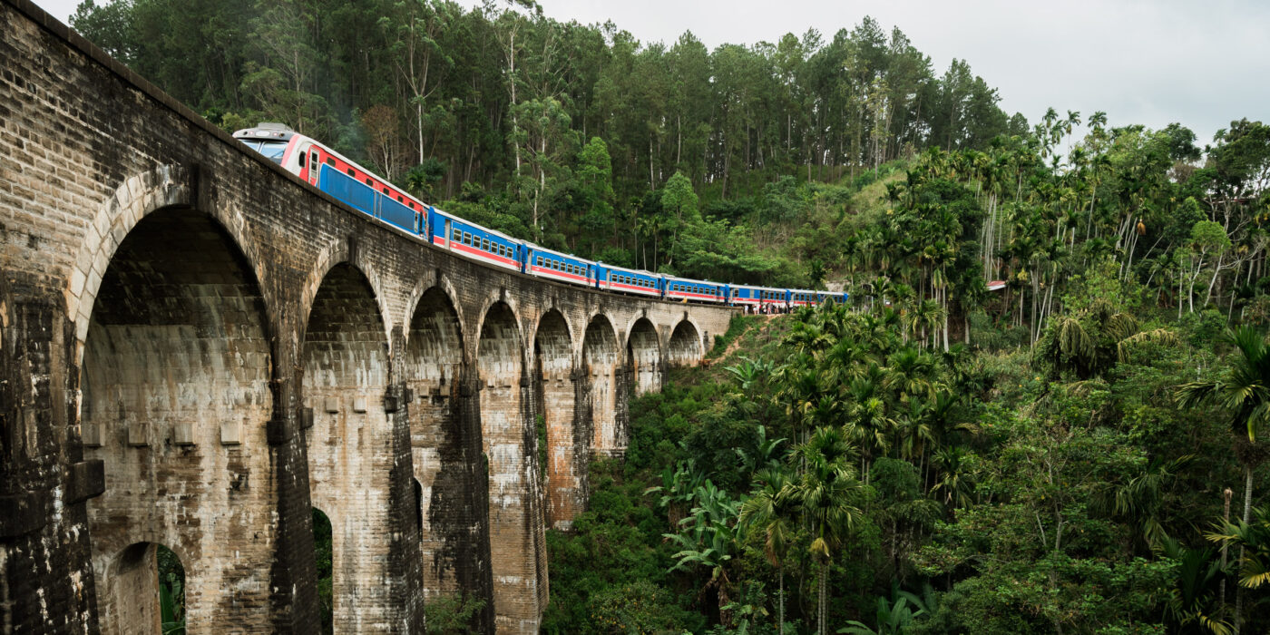 View of Train passing over the famous Nine Arches bridge in Ella, Sri Lanka