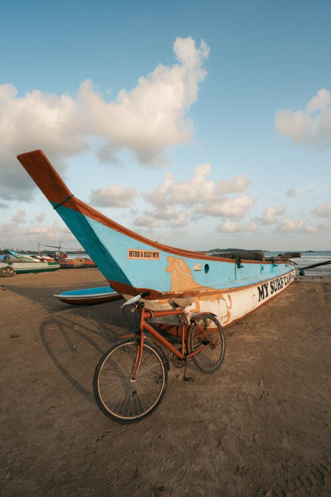 Kayak and bicycle at Weligama beach during sunset