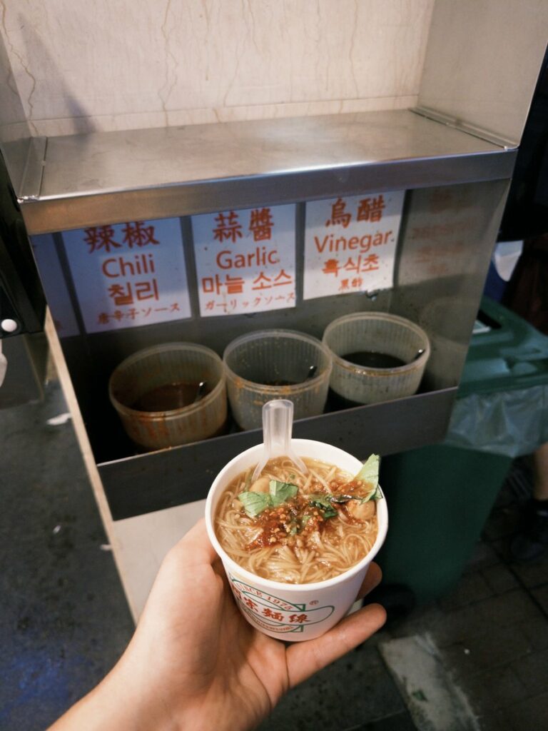Rice noodle bowl at Ay-Chung Flour-Rice Noodle with sauces in the background